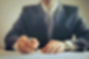 crop-businessman-signing-contract-in-off